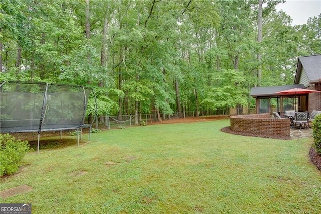view of yard with a trampoline and a gazebo