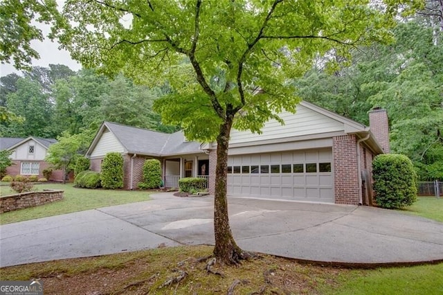 ranch-style house featuring brick siding, an attached garage, concrete driveway, a chimney, and a front yard
