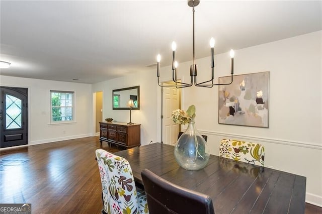 dining space with a chandelier, dark wood-style flooring, and baseboards
