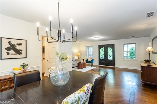 dining space with a chandelier, dark wood-style floors, and baseboards