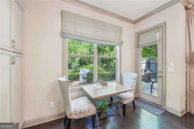 dining area with dark wood finished floors and baseboards