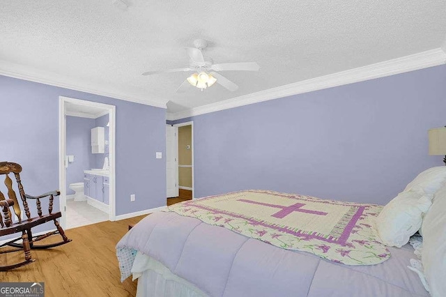 bedroom with crown molding, a textured ceiling, light wood-style flooring, ensuite bathroom, and a ceiling fan