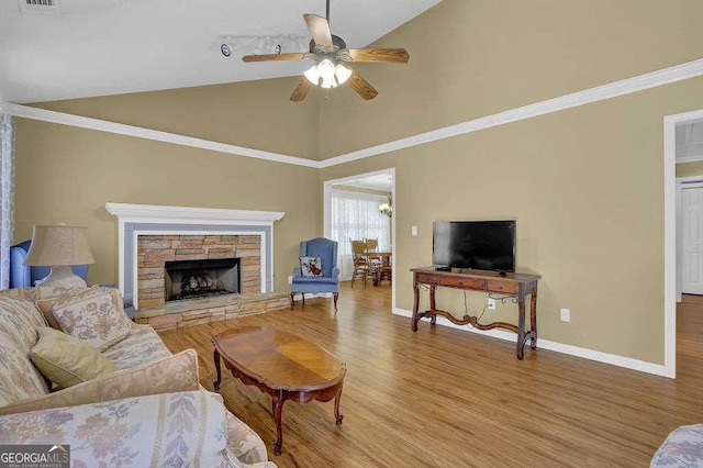 living room featuring a ceiling fan, wood finished floors, baseboards, high vaulted ceiling, and a fireplace