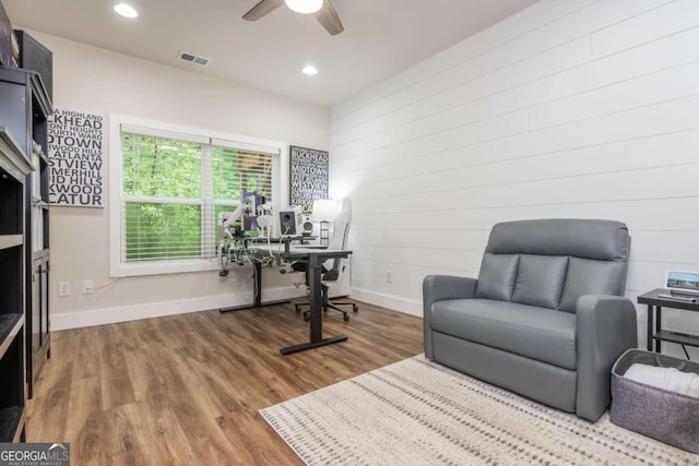 office space featuring baseboards, ceiling fan, wood finished floors, recessed lighting, and wood walls