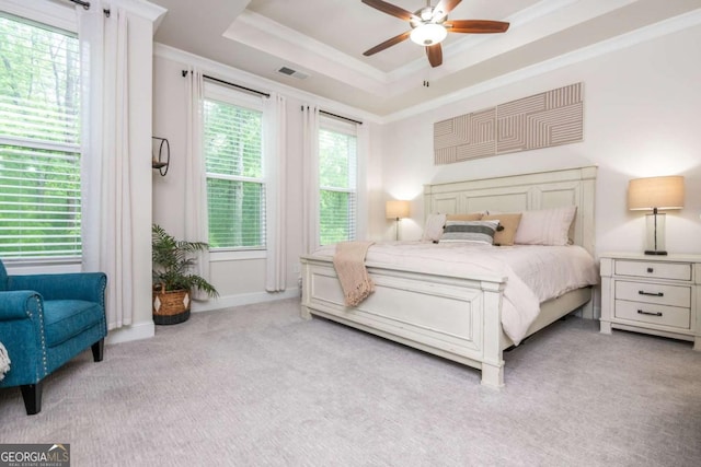 bedroom featuring carpet floors, a raised ceiling, ornamental molding, and ceiling fan
