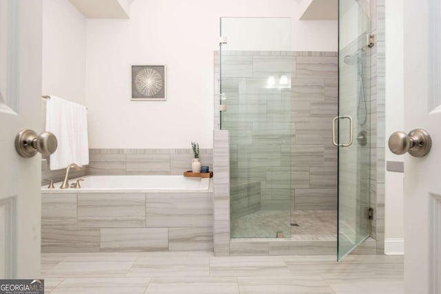 bathroom featuring a garden tub and a stall shower