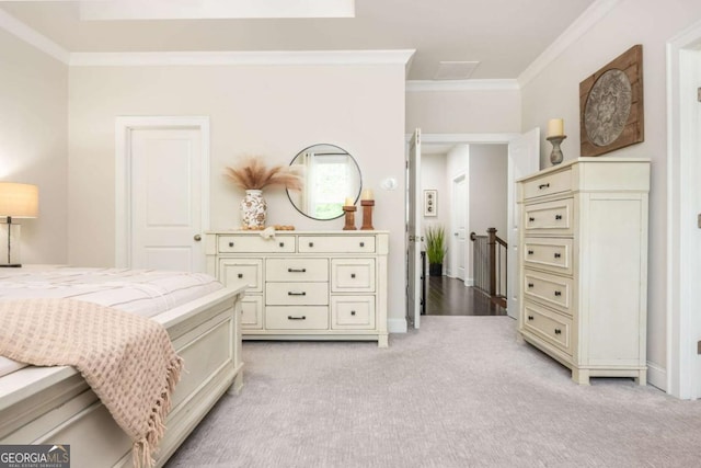 bedroom featuring crown molding, light carpet, and baseboards