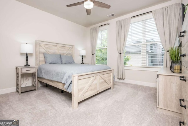 bedroom with baseboards, light carpet, and a ceiling fan