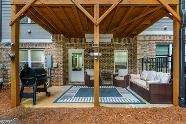 view of patio with area for grilling and an outdoor hangout area