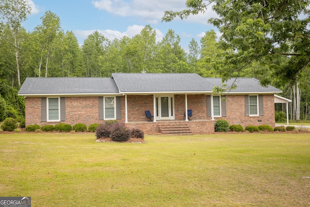 single story home featuring brick siding, a front lawn, and roof with shingles