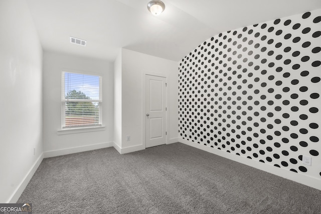 additional living space with dark carpet, baseboards, and lofted ceiling