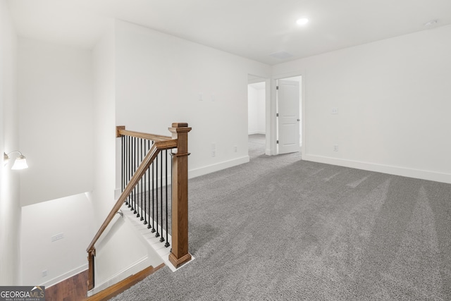 carpeted spare room with baseboards