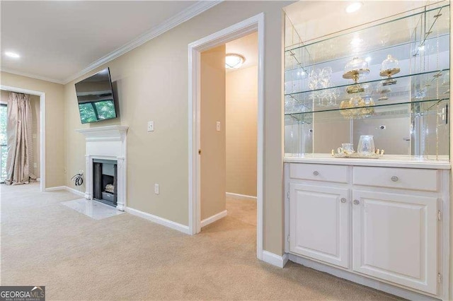 28106 Plantation Dr NE, Atlanta, GA 30324 - unfurnished living room featuring light carpet, ornamental molding, baseboards, a fireplace with flush hearth, and a bar
