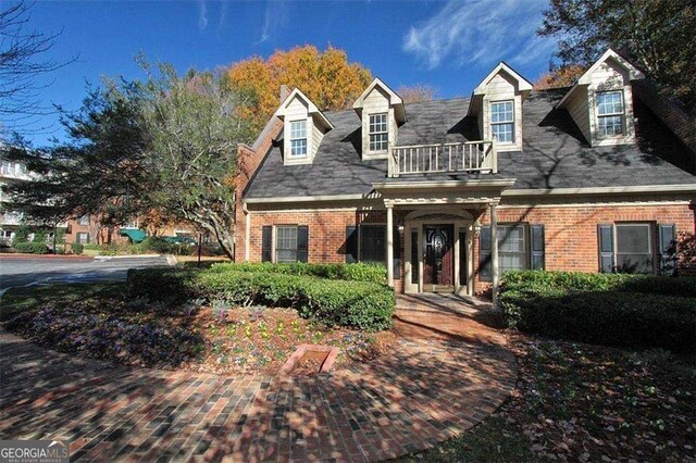 28106 Plantation Dr NE, Atlanta, GA 30324 - new england style home featuring brick siding and a balcony