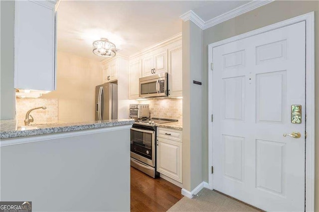 28106 Plantation Dr NE, Atlanta, GA 30324 - kitchen featuring stainless steel appliances, backsplash, light stone counters, a sink, and crown molding
