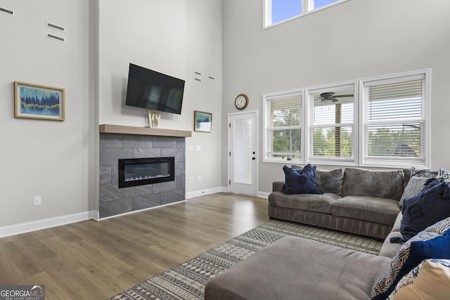 2436 Hidden Creek Rd, Kennesaw, GA 30152 - living area featuring a high ceiling, healthy amount of natural light, wood finished floors, and baseboards