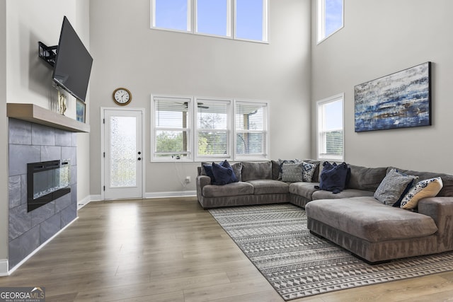 2436 Hidden Creek Rd, Kennesaw, GA 30152 - living room with a high ceiling, a fireplace, plenty of natural light, baseboards, and wood finished floors