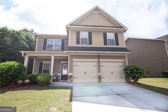 4271 Haywater Cv, Buford, GA 30519 - craftsman-style home with an attached garage, driveway, a front yard, and covered porch