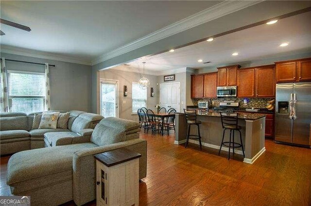 4271 Haywater Cv, Buford, GA 30519 - living area featuring dark wood-style floors, a chandelier, crown molding, recessed lighting, and baseboards