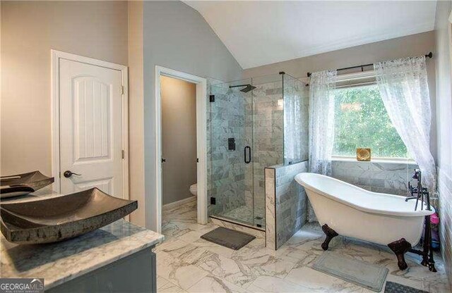 4271 Haywater Cv, Buford, GA 30519 - full bathroom with lofted ceiling, a stall shower, a soaking tub, marble finish floors, and toilet