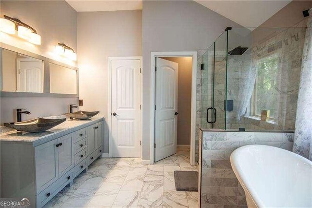 4271 Haywater Cv, Buford, GA 30519 - full bath with a shower stall, marble look tile flooring, a freestanding tub, double vanity, and lofted ceiling
