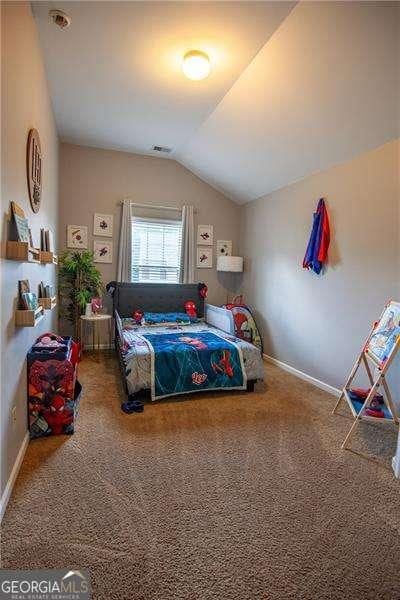 4271 Haywater Cv, Buford, GA 30519 - bedroom with lofted ceiling, carpet, and baseboards