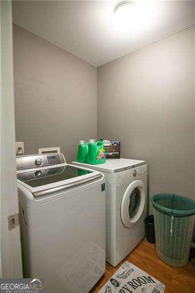 4271 Haywater Cv, Buford, GA 30519 - washroom featuring washing machine and dryer and light wood-type flooring