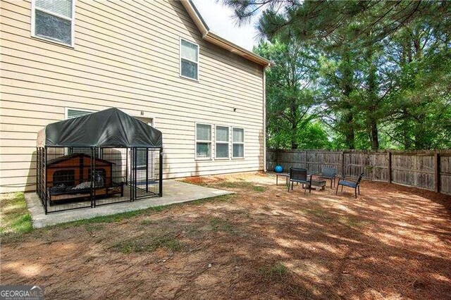4271 Haywater Cv, Buford, GA 30519 - back of property featuring a fenced backyard and an outdoor fire pit
