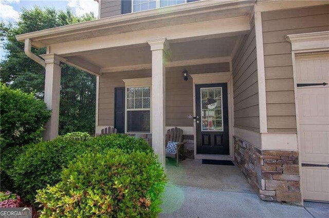 4271 Haywater Cv, Buford, GA 30519 - property entrance with a porch and stone siding