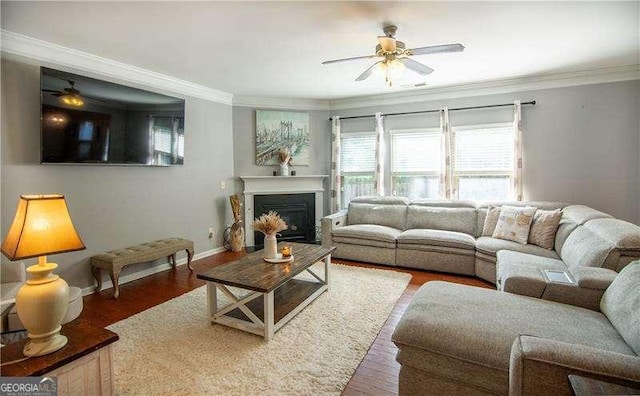 4271 Haywater Cv, Buford, GA 30519 - living area featuring a ceiling fan, crown molding, wood finished floors, baseboards, and a fireplace