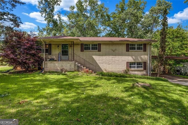 view of front of property with a carport, brick siding, and a front yard