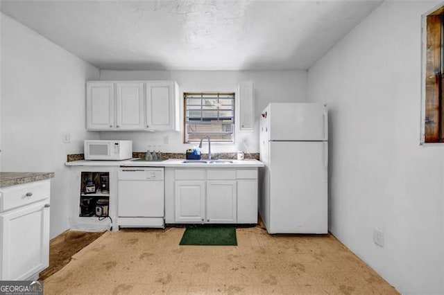 kitchen with white appliances, a sink, white cabinets, and light countertops