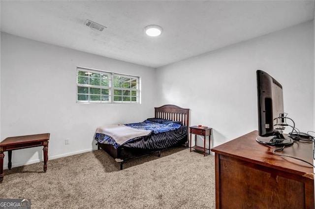 bedroom featuring carpet and baseboards