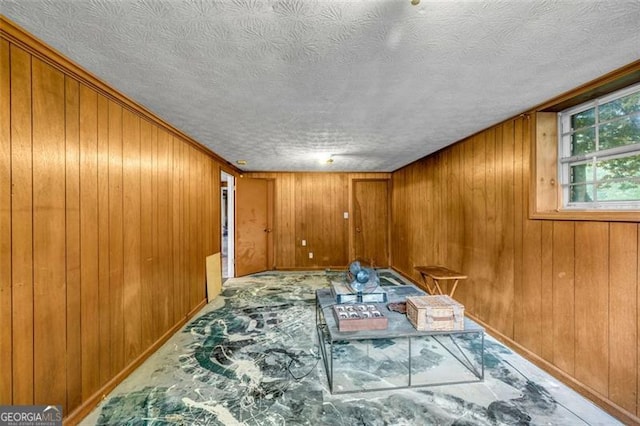 empty room featuring wood walls and baseboards