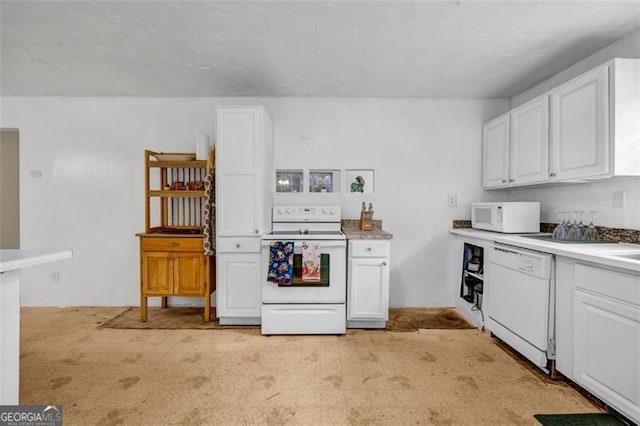 kitchen with white appliances, white cabinets, light countertops, and light colored carpet