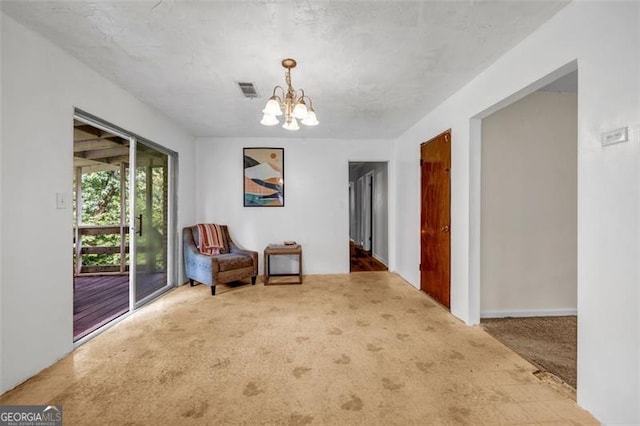 living area with carpet flooring and a chandelier