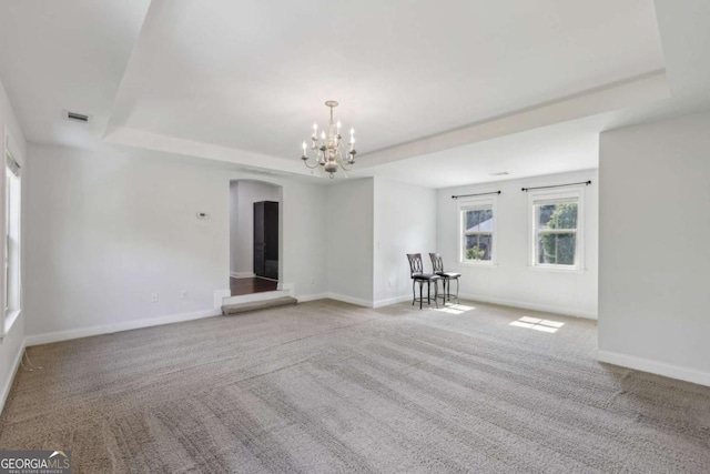 4630 Carriage Walk Ln, Cumming, GA 30040 - carpeted spare room with a raised ceiling, arched walkways, and a chandelier