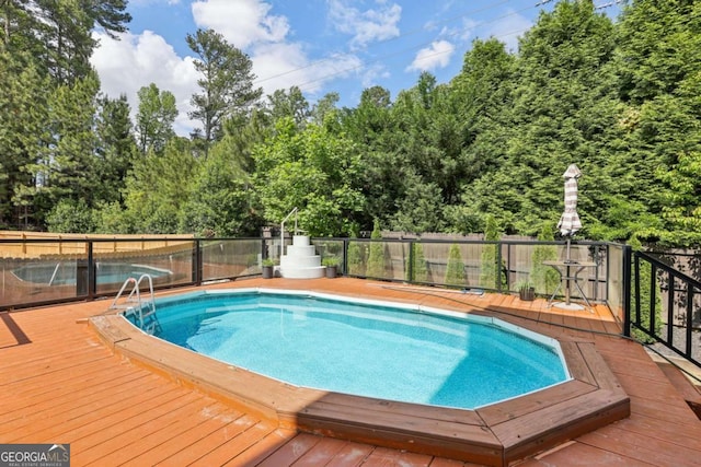 4630 Carriage Walk Ln, Cumming, GA 30040 - view of swimming pool with a wooden deck and view of wooded area