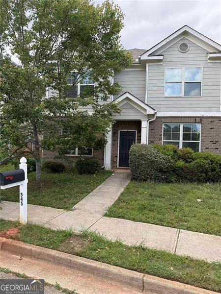 view of front of house with brick siding and a front yard