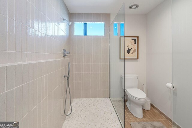 3235 Roswell Rd NE Unit 617, Atlanta, GA 30305 - bathroom featuring toilet, a walk in shower, and tile patterned floors