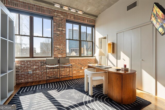 3235 Roswell Rd NE Unit 617, Atlanta, GA 30305 - home office featuring wood finished floors and brick wall