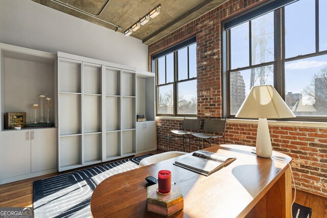 3235 Roswell Rd NE Unit 617, Atlanta, GA 30305 - office featuring brick wall, wood finished floors, and rail lighting