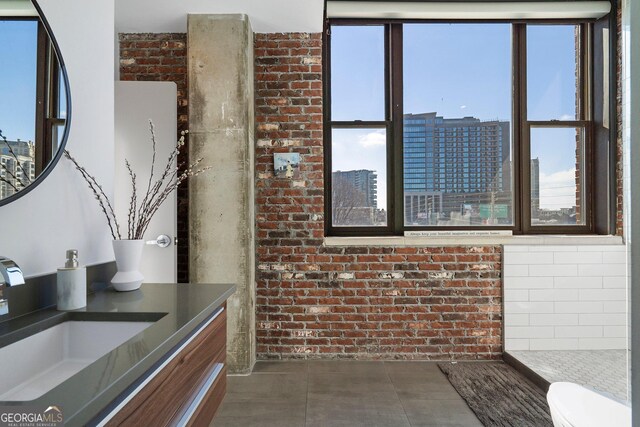 3235 Roswell Rd NE Unit 617, Atlanta, GA 30305 - bathroom with toilet, vanity, a view of city, and brick wall