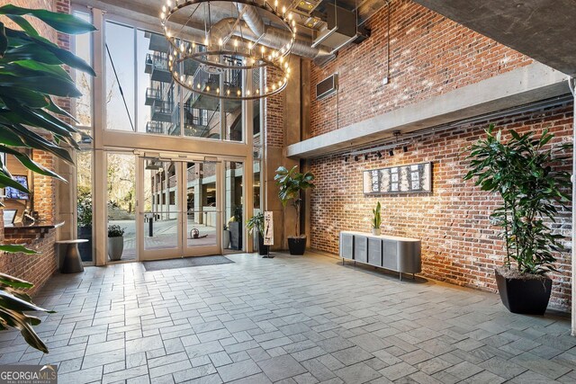 3235 Roswell Rd NE Unit 617, Atlanta, GA 30305 - community lobby with a towering ceiling and brick wall