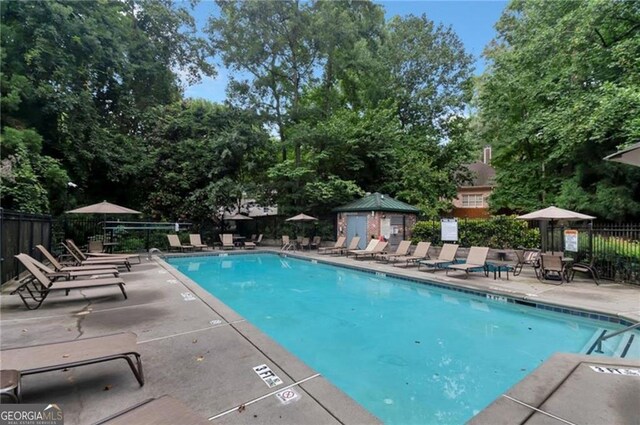 3235 Roswell Rd NE Unit 617, Atlanta, GA 30305 - community pool featuring fence, a patio, and view of wooded area