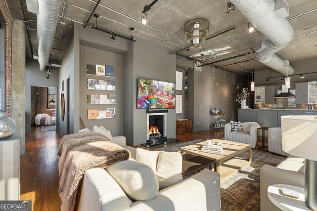 3235 Roswell Rd NE Unit 617, Atlanta, GA 30305 - living area with wood finished floors, a warm lit fireplace, and a high ceiling