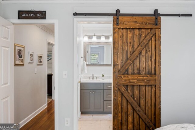 bathroom featuring vanity, baseboards, and crown molding
