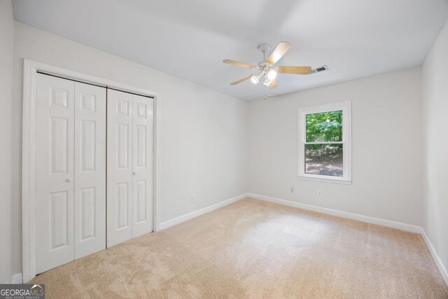 unfurnished bedroom featuring carpet, a closet, and baseboards