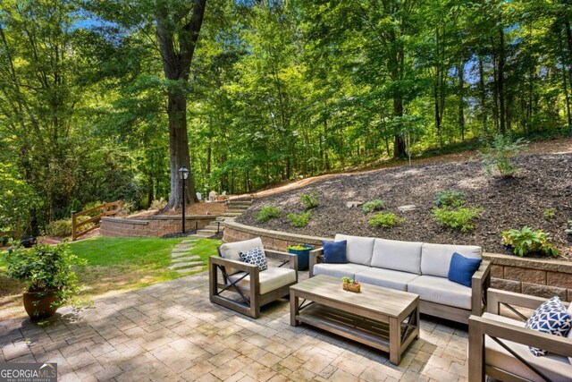 view of patio / terrace with outdoor lounge area and a wooded view