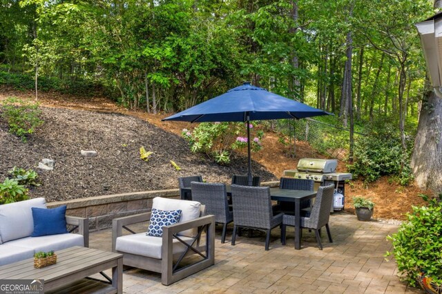 view of patio with outdoor dining space, an outdoor hangout area, and a grill